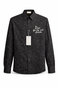 Dior featuring a speckled pattern and a white embroidered phrase on the pocket.